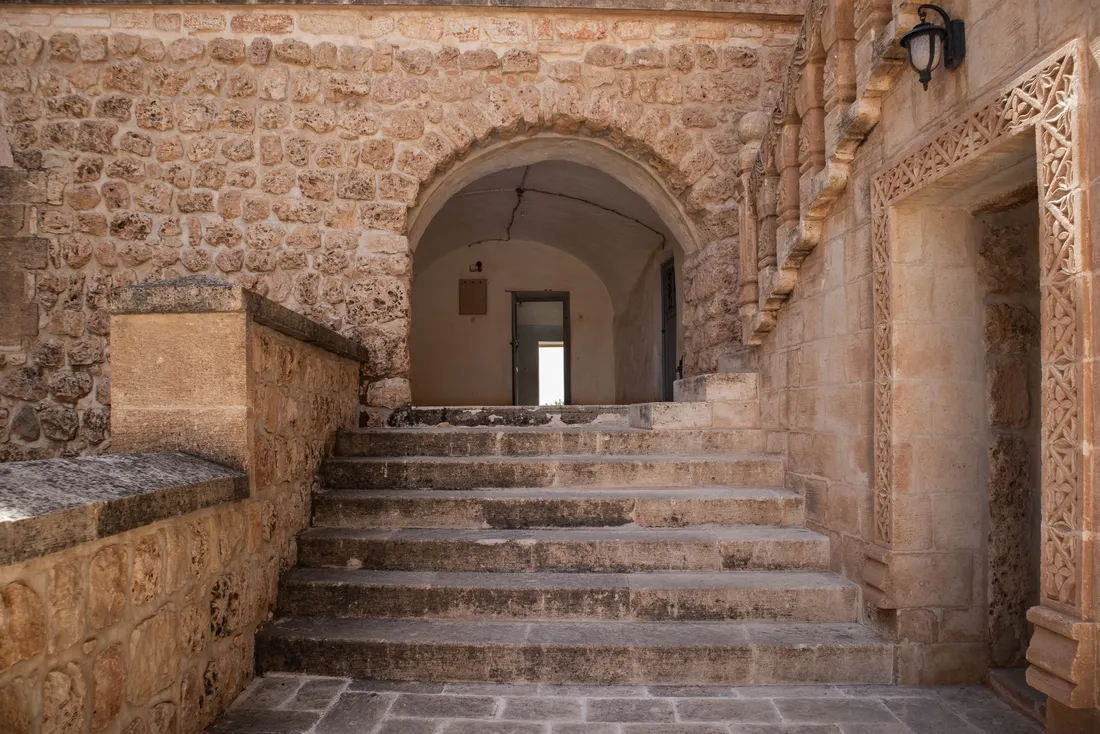Escalier de pierre sous une arche dans la cour d'une maison ancienne (Varreddes, Seine-et-Marne)